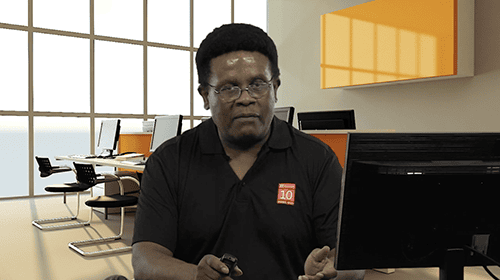 AIIT training session with instructor in a bright, modern classroom environment.