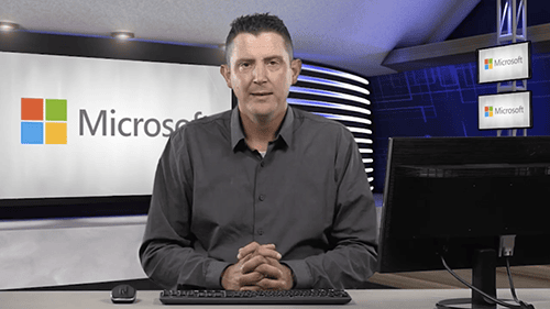 Man presenting AIIT technology in a modern studio setting.